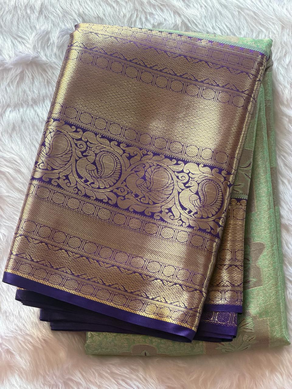 Close-up of purple and gold zari peacock motif border on sea green Kanchipuram polyester saree