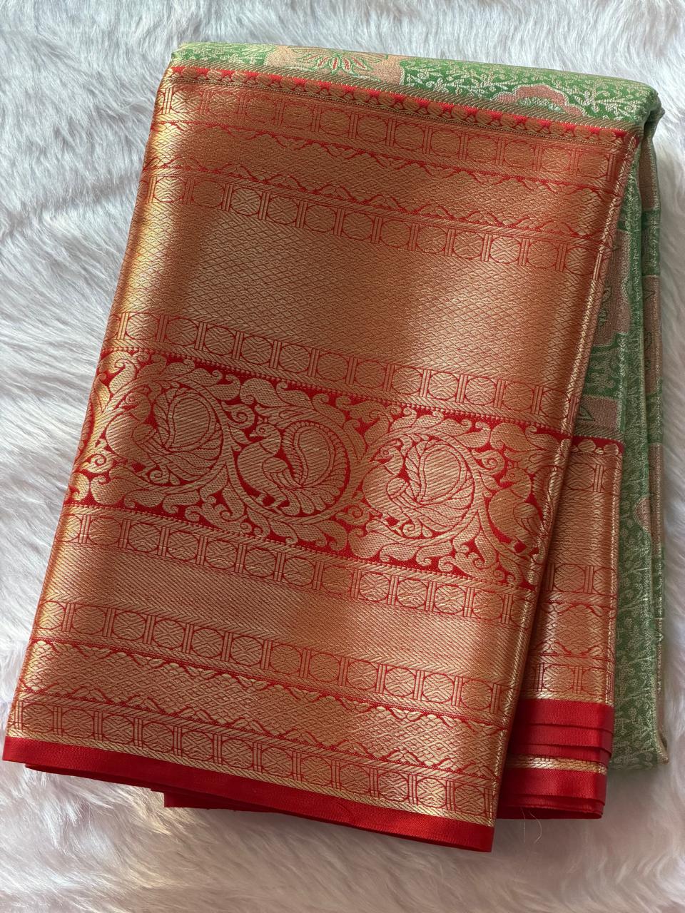 Reddish-orange zari contrast border with traditional motifs on green brocade Kanchipuram polyester saree