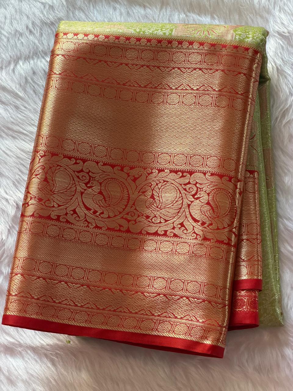 Red and gold zari border with traditional elephant and temple motifs on sage green Kanchipuram saree