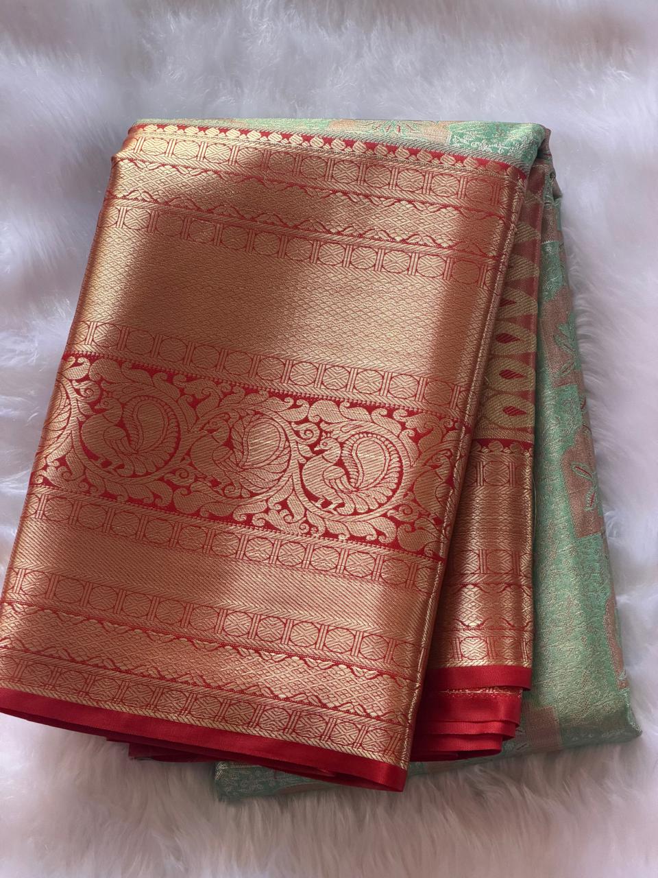 Kumkum red contrast border with gold zari peacock motifs on vibhuti green Kanchipuram polyester saree