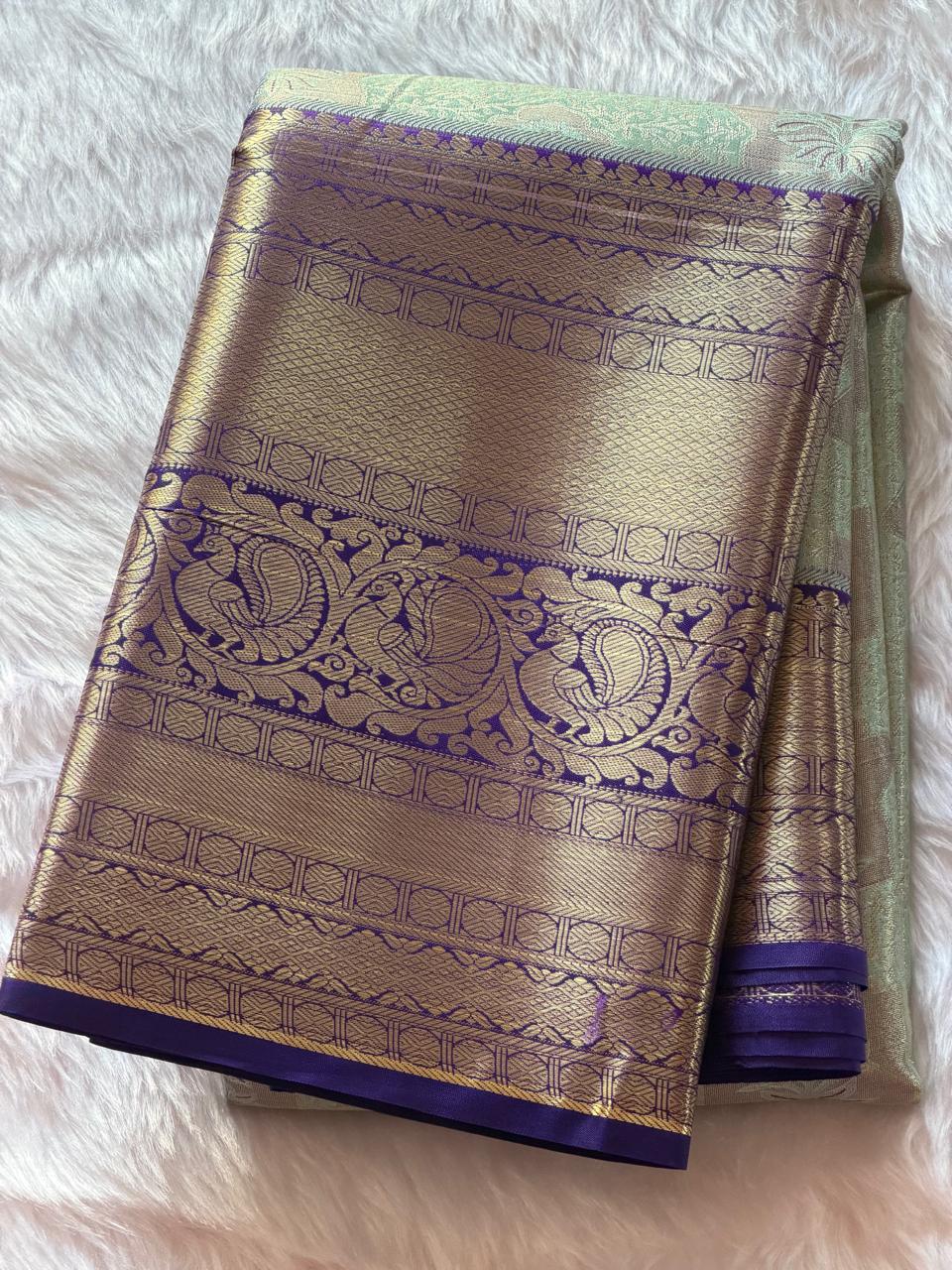 Rich purple border with intricate gold zari peacock motifs on sage green Kanchipuram polyester saree