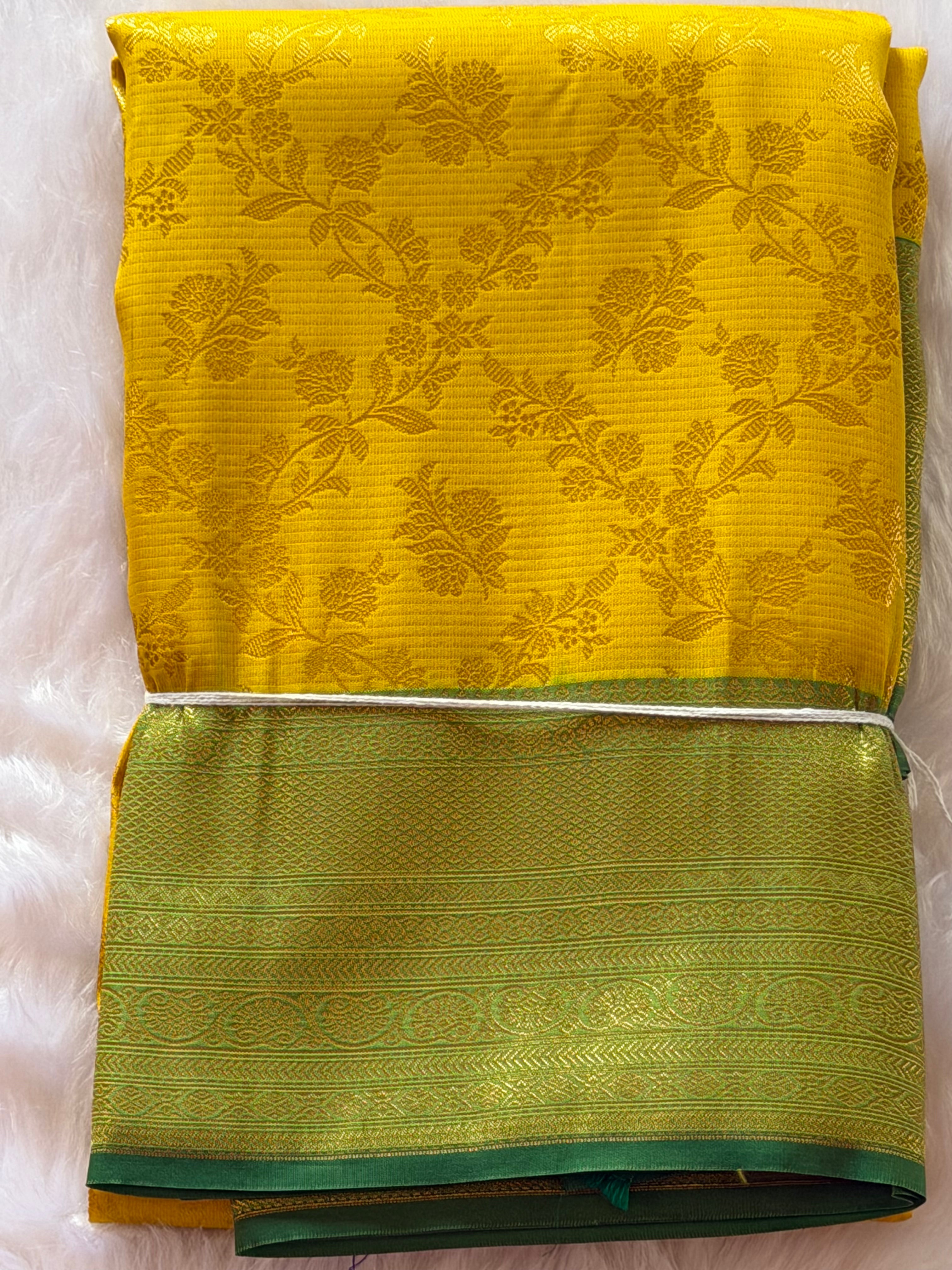Mustard yellow Kanchipuram polyester saree draped view - radiant with sage green contrast border