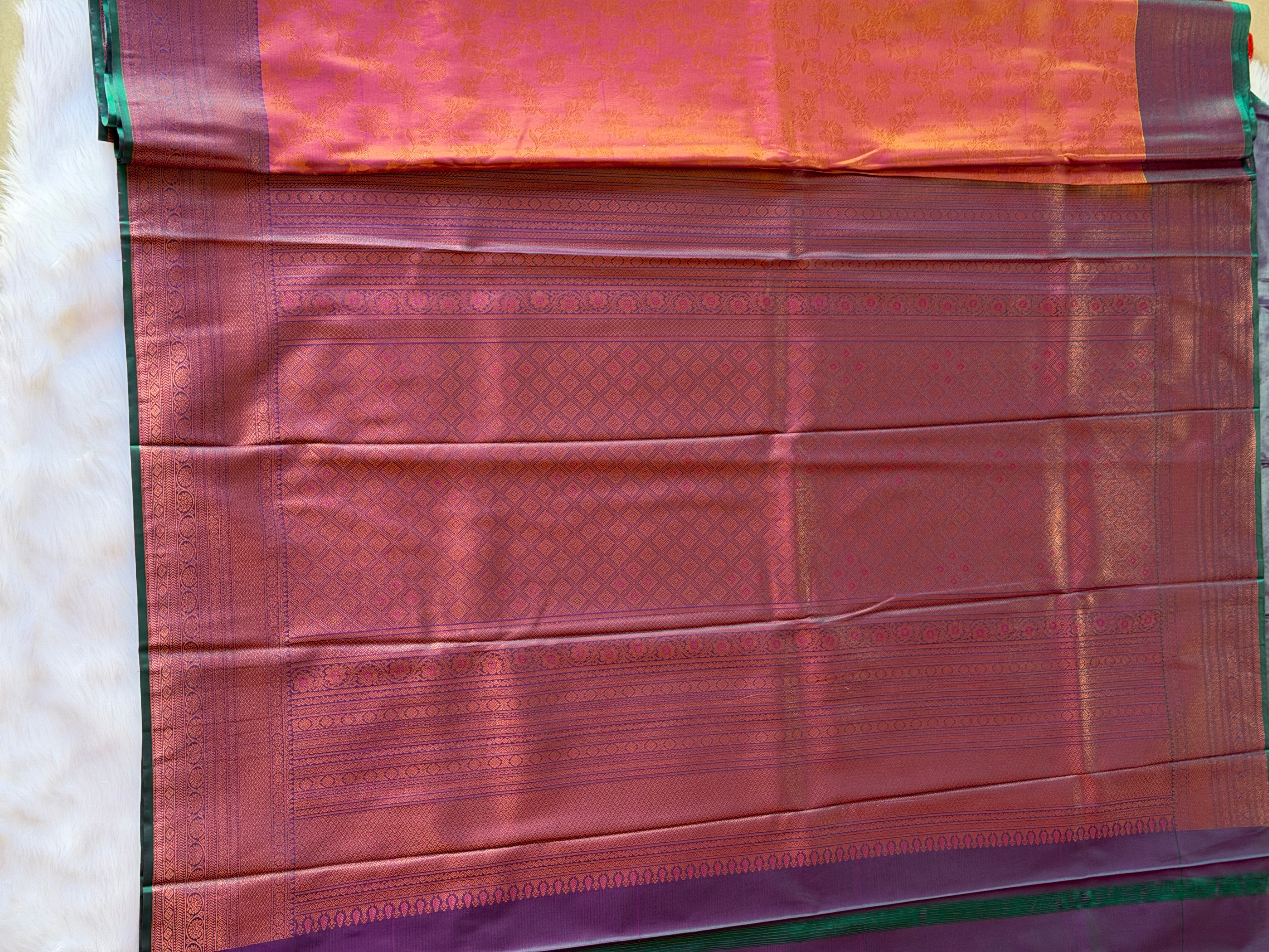 Deep purple zari contrast border on russet orange Kanchipuram polyester saree