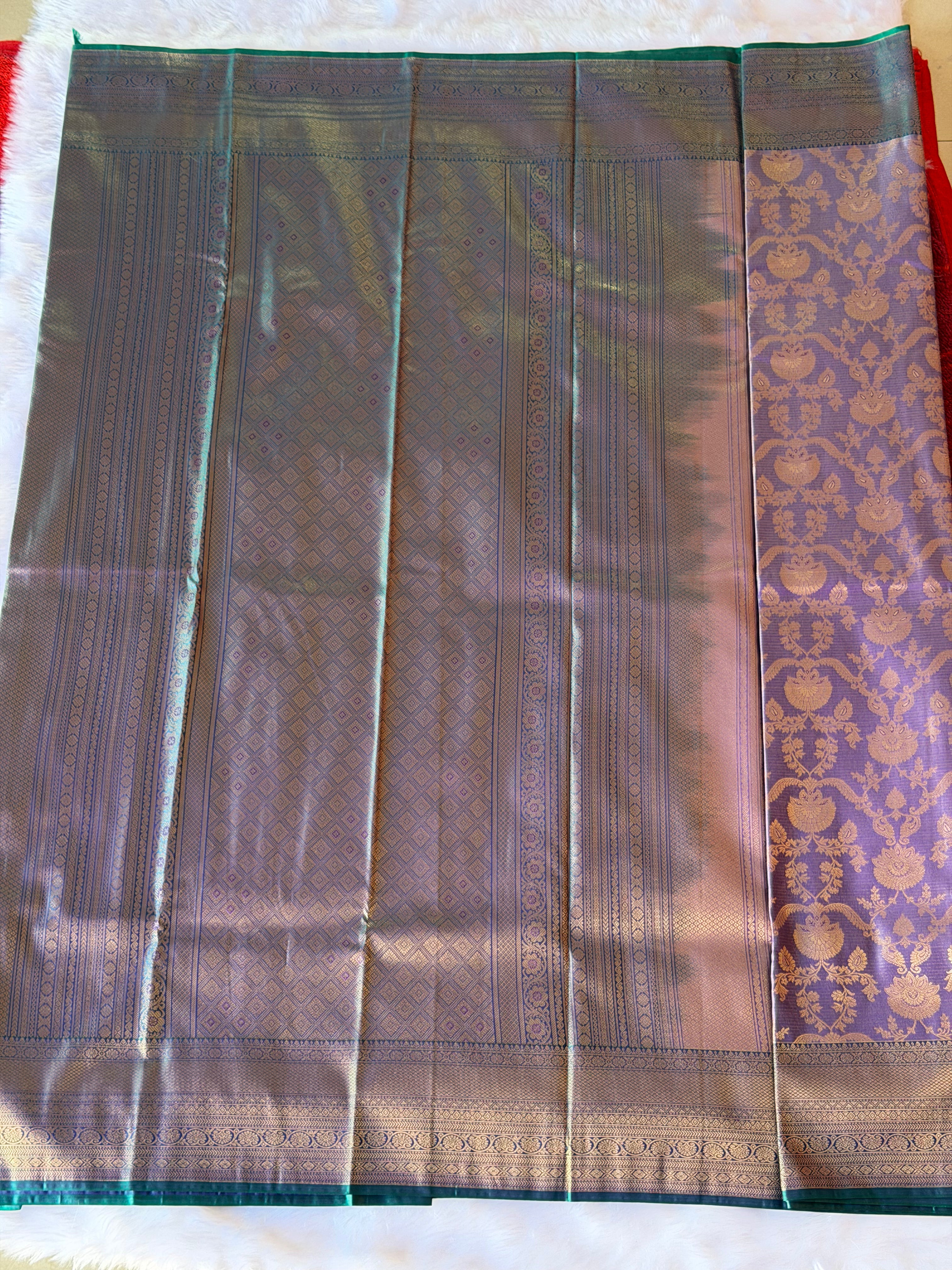 Contrasting emerald green zari border on soft lavender Kanchipuram polyester saree