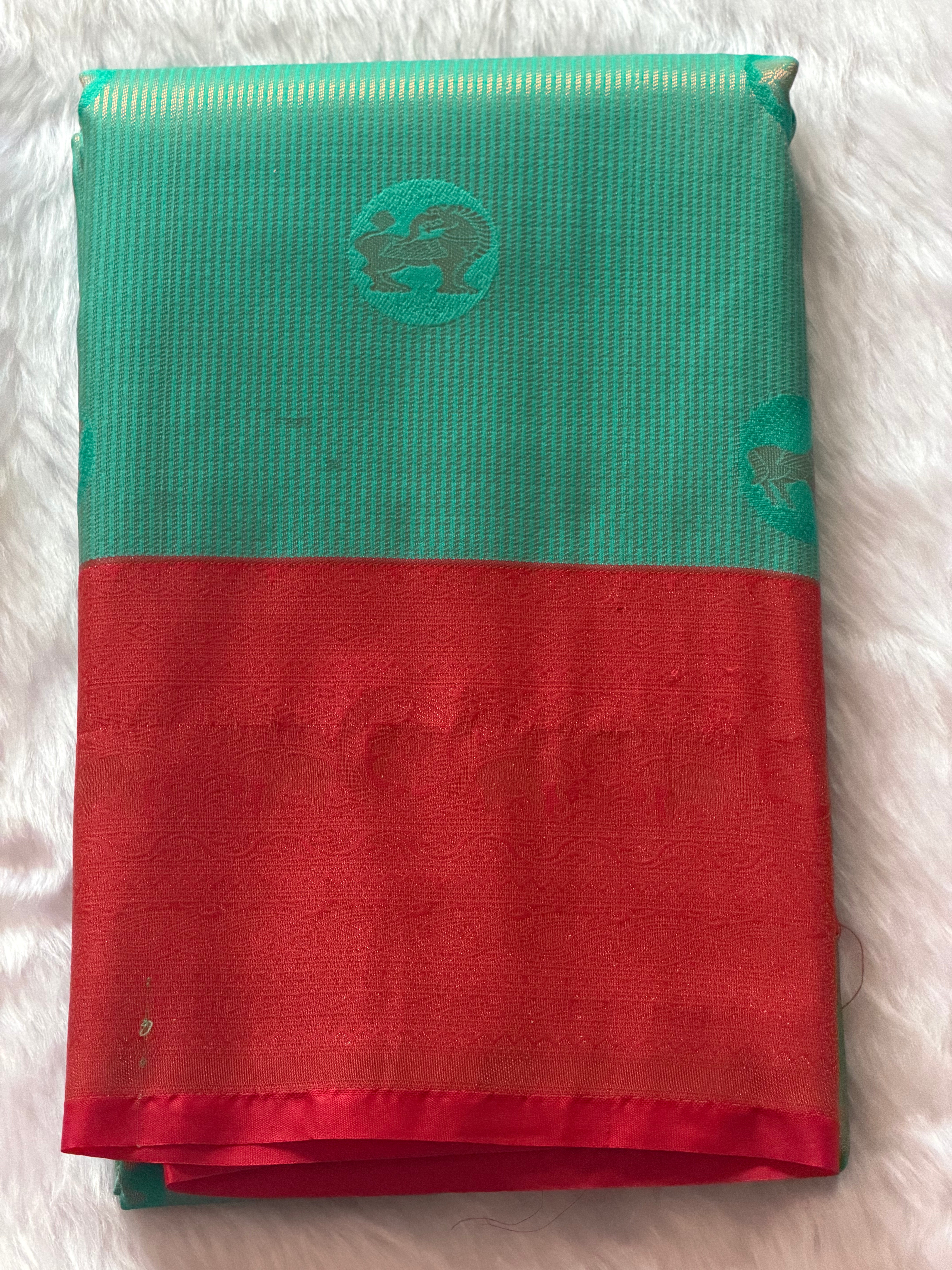 Seafoam green Kanchipuram polyester saree with deep red elephant and floral motif zari border