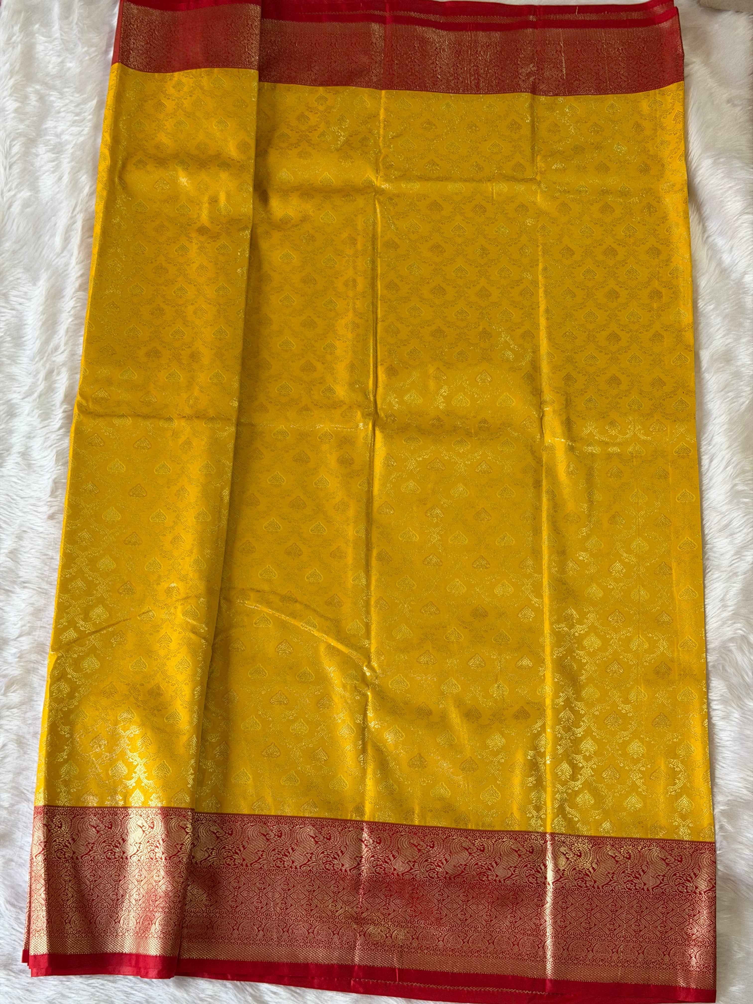 Red zari contrast border on mustard yellow Kanchipuram polyester saree - traditional South Indian