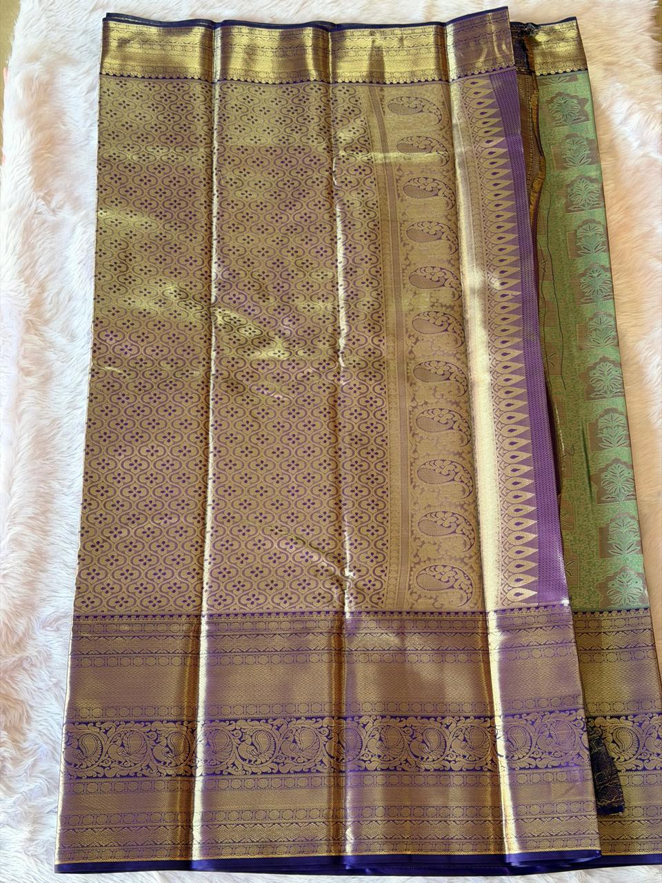 Pallu detail of sea green Kanchipuram polyester saree with golden zari peacock motifs